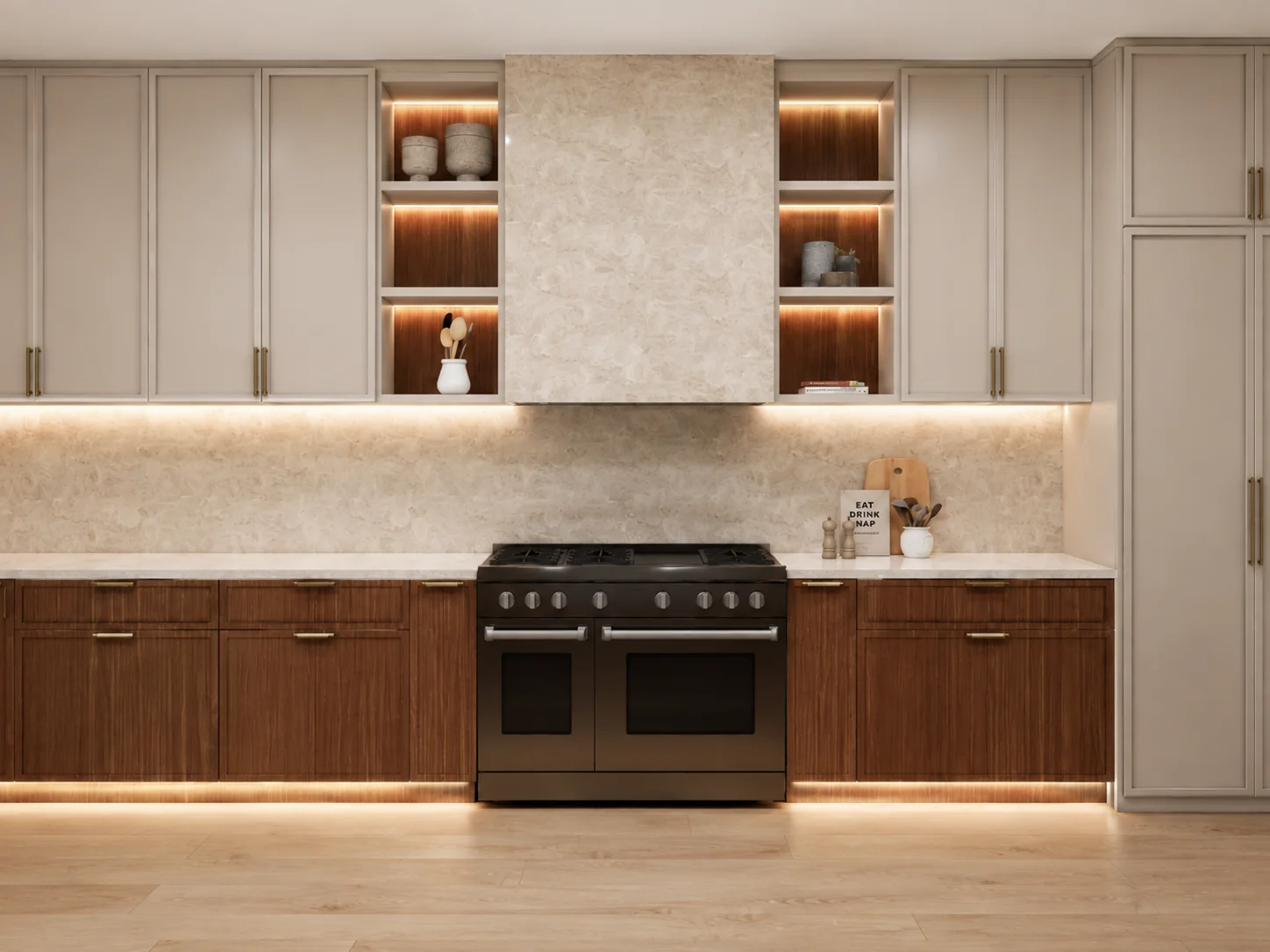 Chef's kitchen with waterfall stone island, natural stone hood, and backlit walnut niches